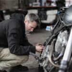 A guy tuning and repairing a motorcycle