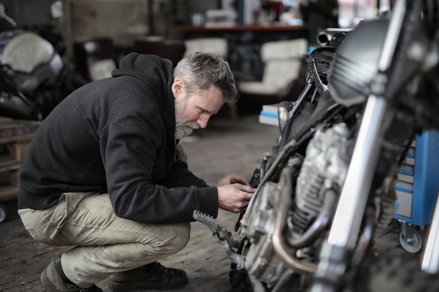 A guy tuning and repairing a motorcycle