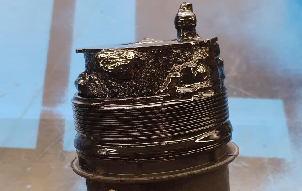 Motorcycle oil filter - old and filled with sludge