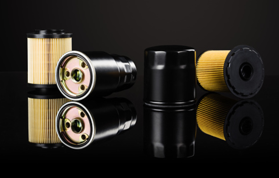 4 oil filters on a black background