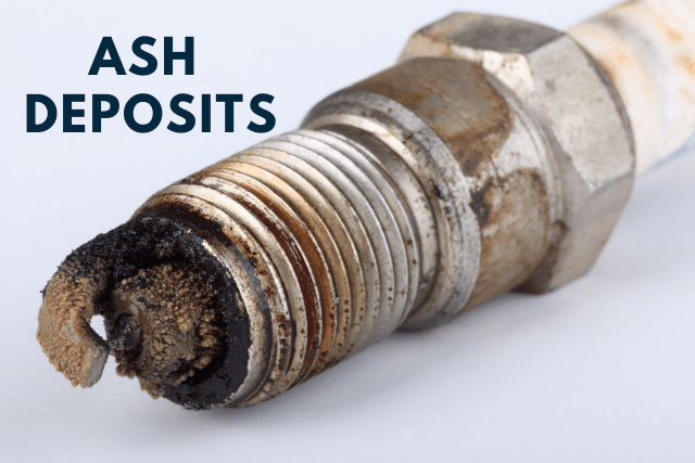 Ash deposits on spark plug with text