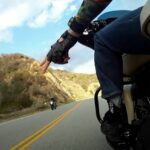Upside down V hand gesture by a motorcycle rider