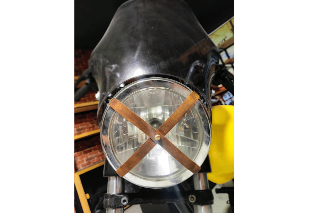X tape on motorcyce headlight