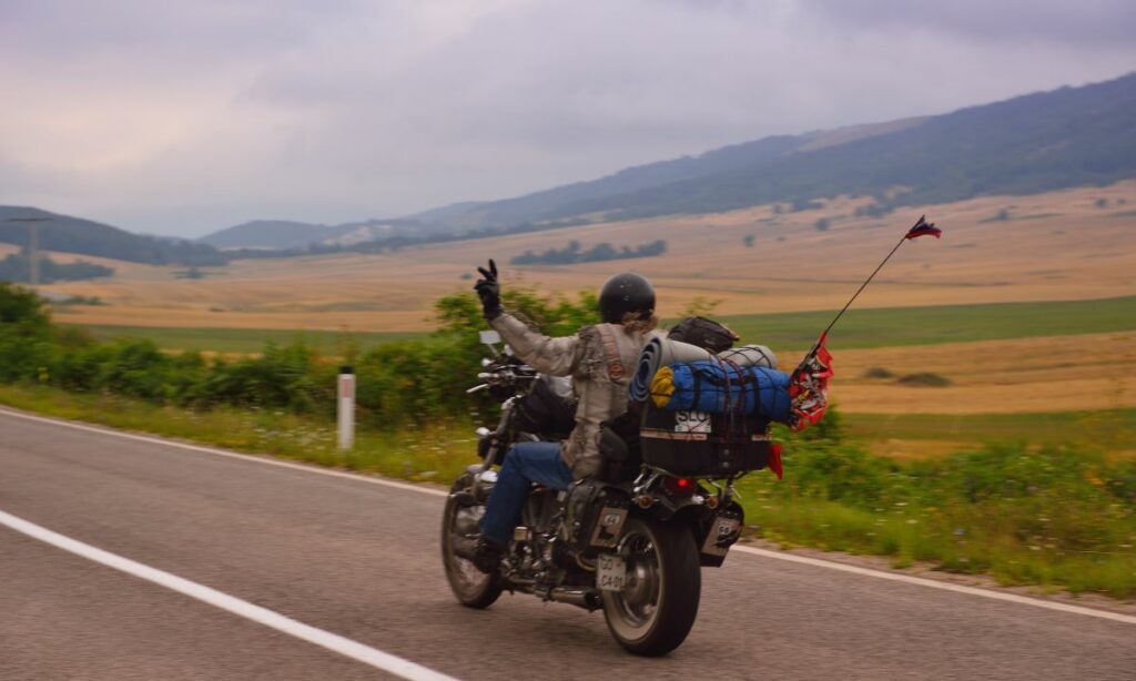 Motorcycle rider waving a V sign