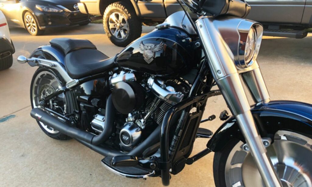 Black Harley motorcycle with 2 into 1 exhaust parked