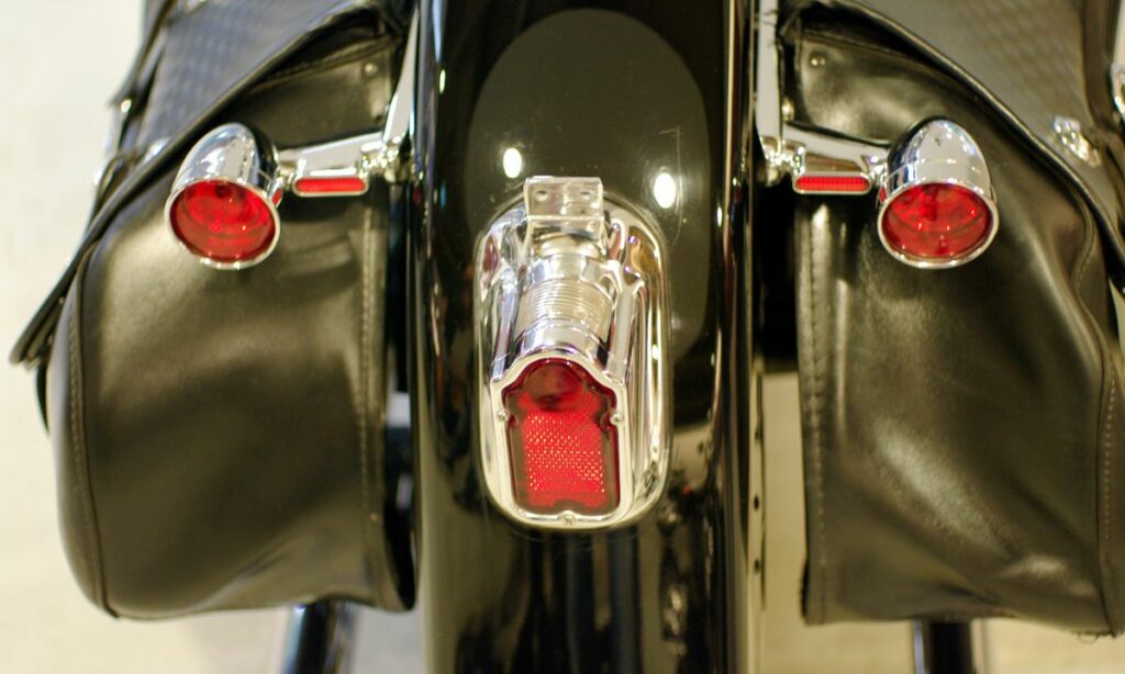 The rear view of a motorcycle fender with red tail light