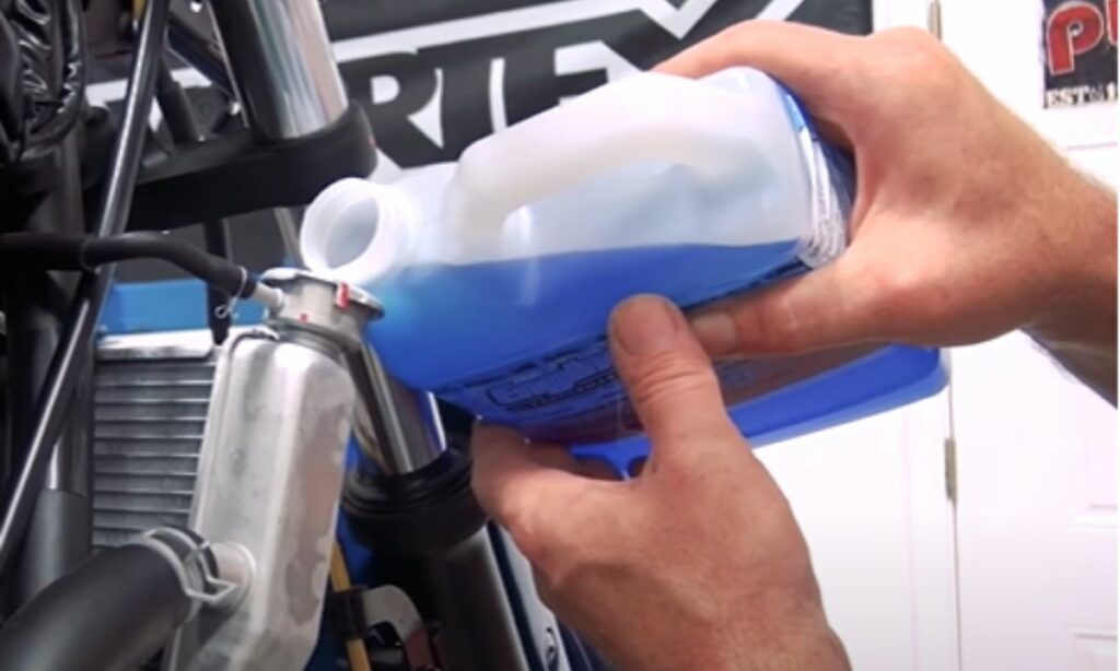 Pouring the coolant on a motorcycle