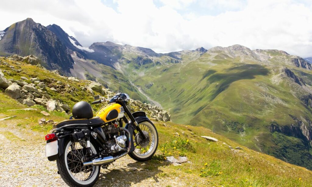 A Motorcycle parked in front of mountains