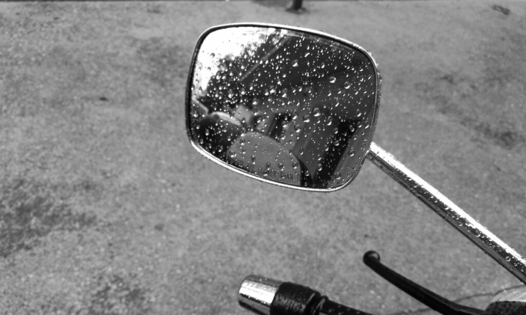 Rain droplets on motorcycle mirror