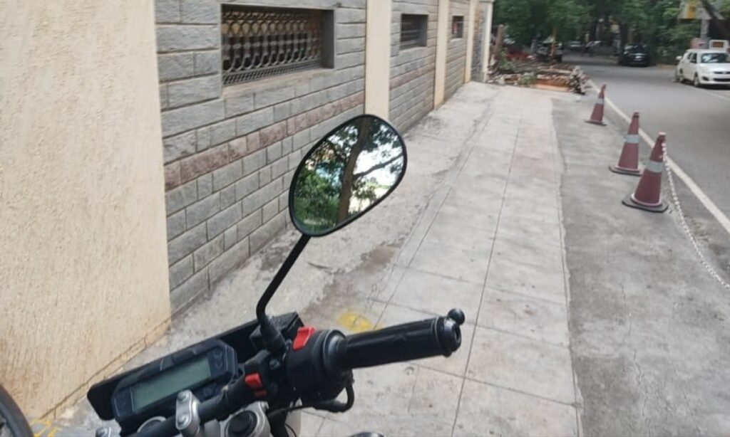 Motorcycle front portion with the image focus on its mirror
