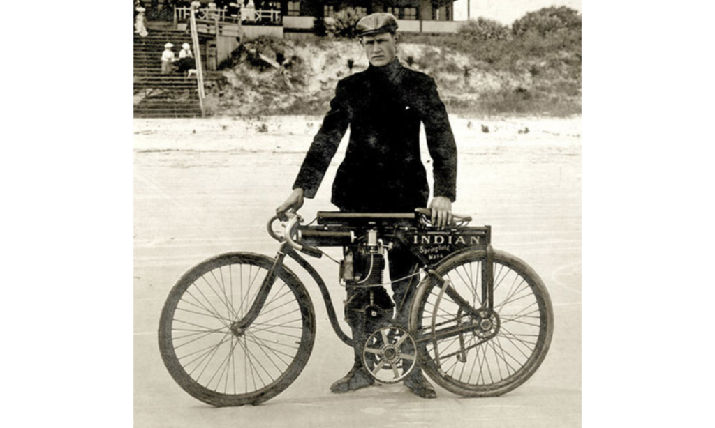 Oscar Herdstrom standing with the first Indian Motorcycle prototype
