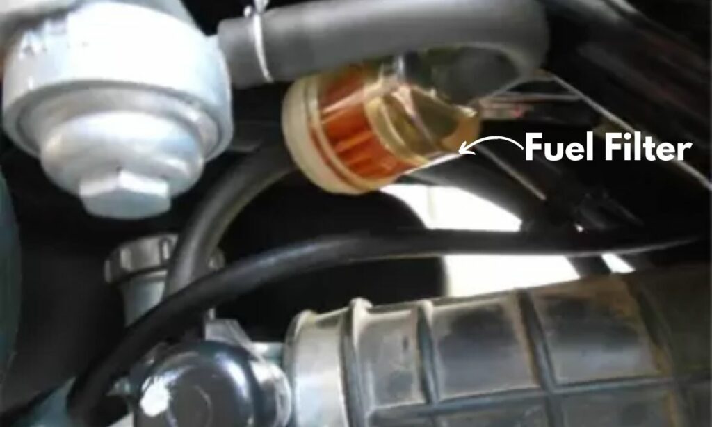 Motorcycle fuel filter located below the gas tank