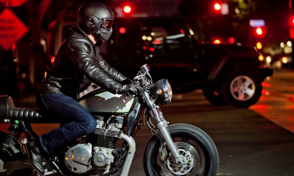 A motorcycle rider on his bike during night time