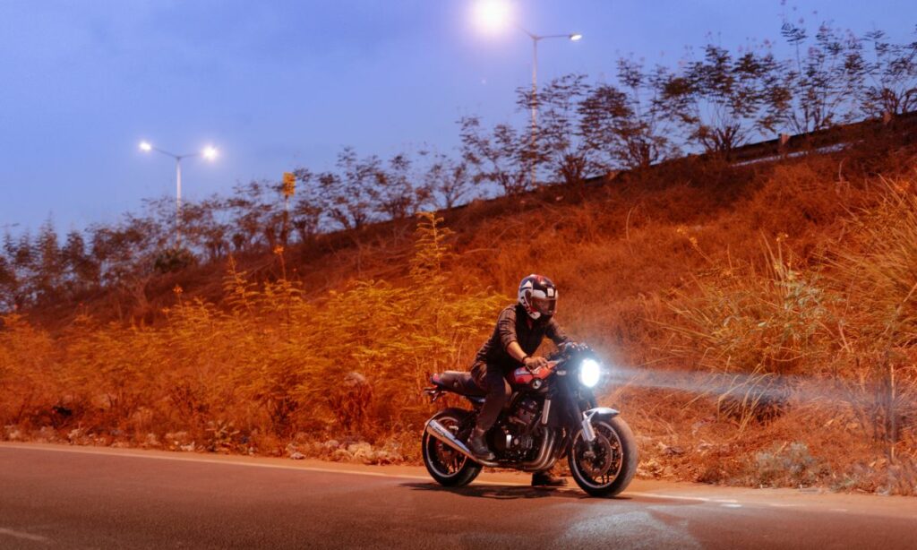 Motorcycle rider with his bike with the headlight on