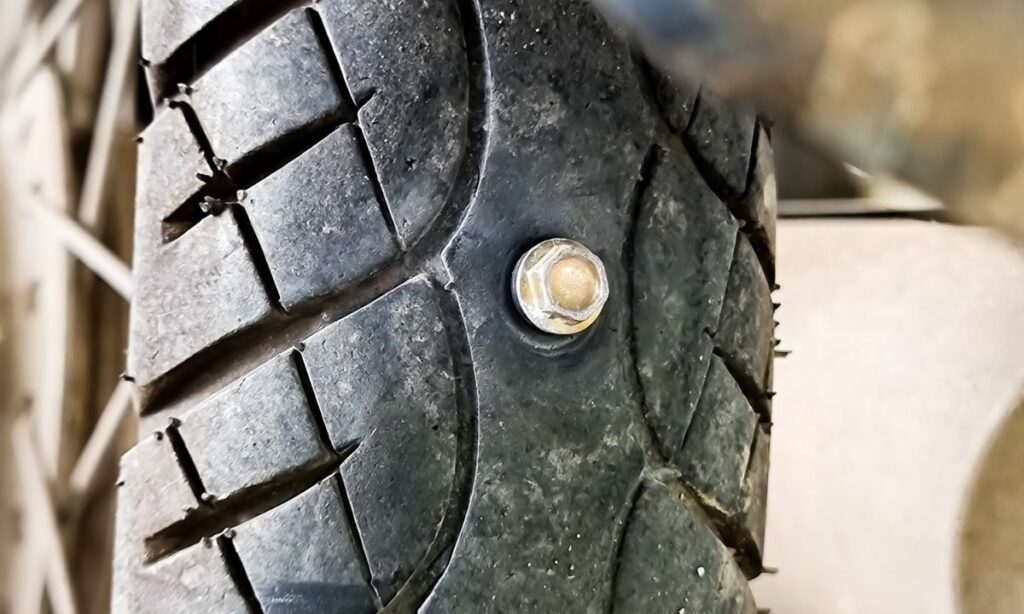 Motorcycle tire punctured by a large nail
