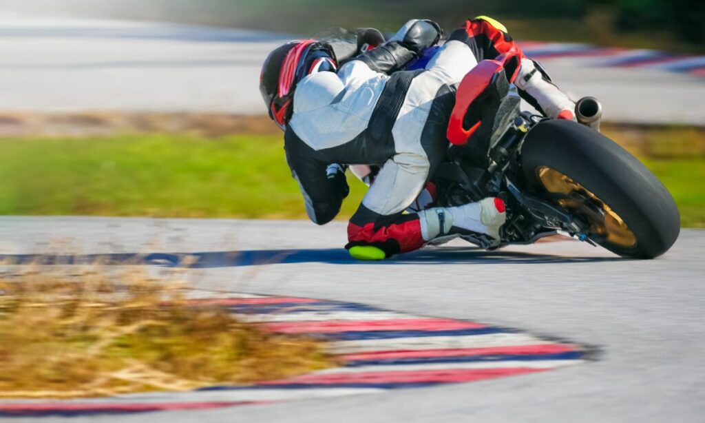 MotoGP rider with knee down while cornering