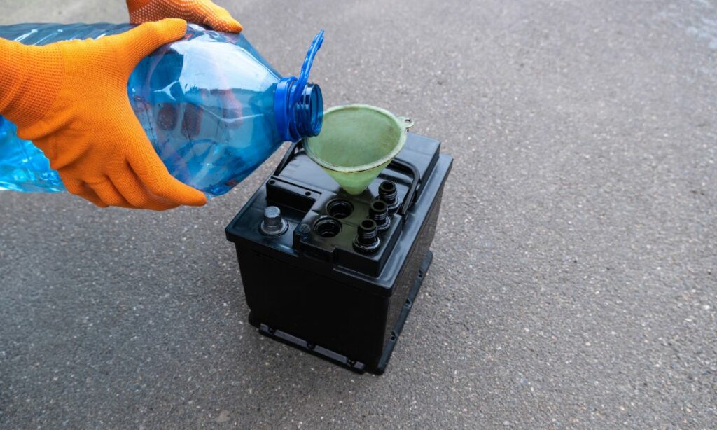 Pouring distilled water to a lead acid battery