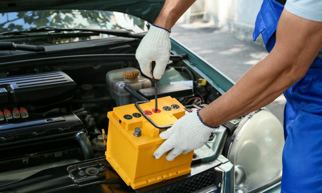 A guy handling lead acid battery of a car