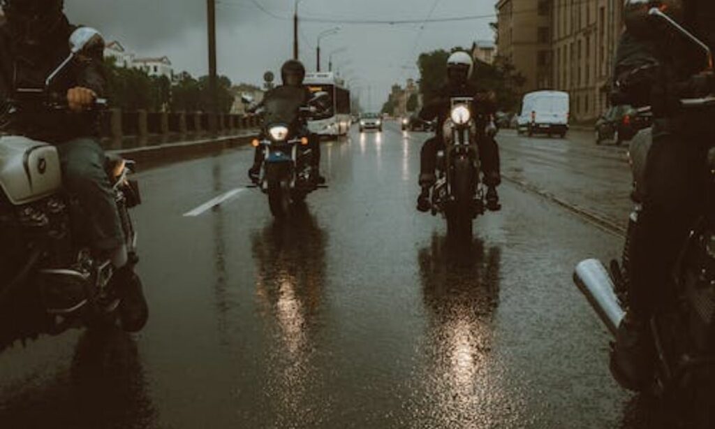 Motorcycle riders riding bikes in rain